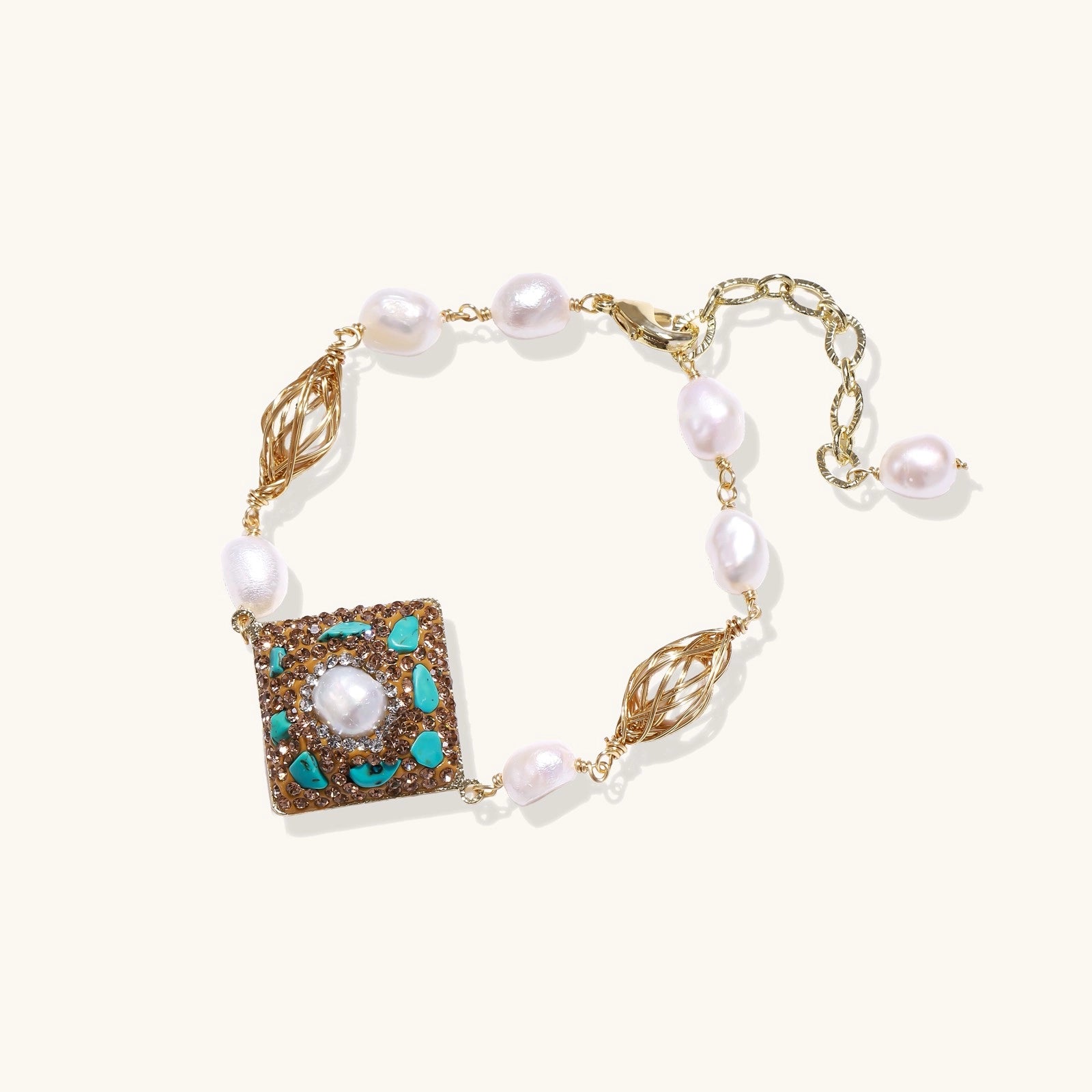 Ornate gold-plated bracelet with square turquoise and crystal centerpiece, freshwater pearls, and decorative chain links