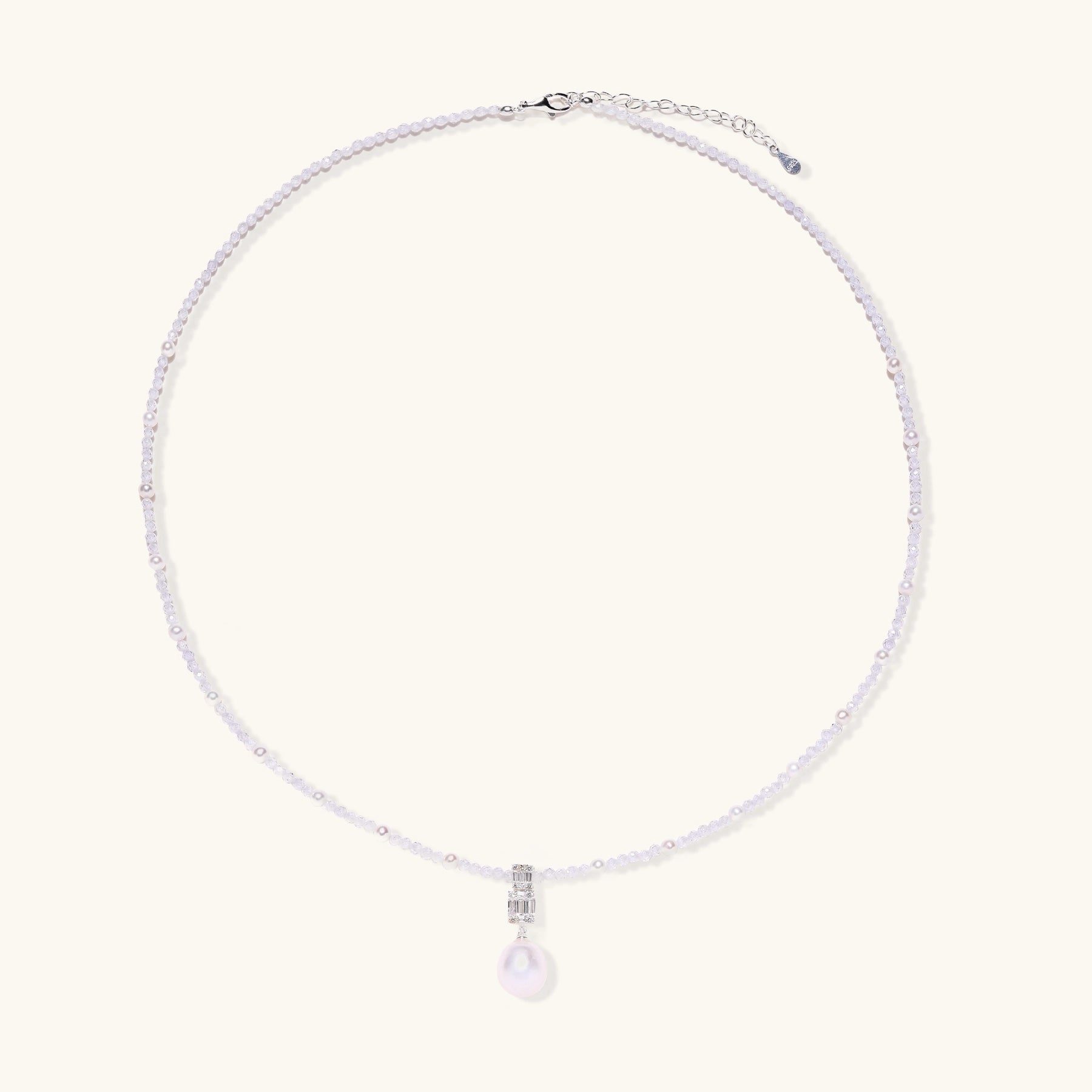 Delicate beaded necklace with lavender crystals, white pearls, and crystal pendant with pearl drop on white background.