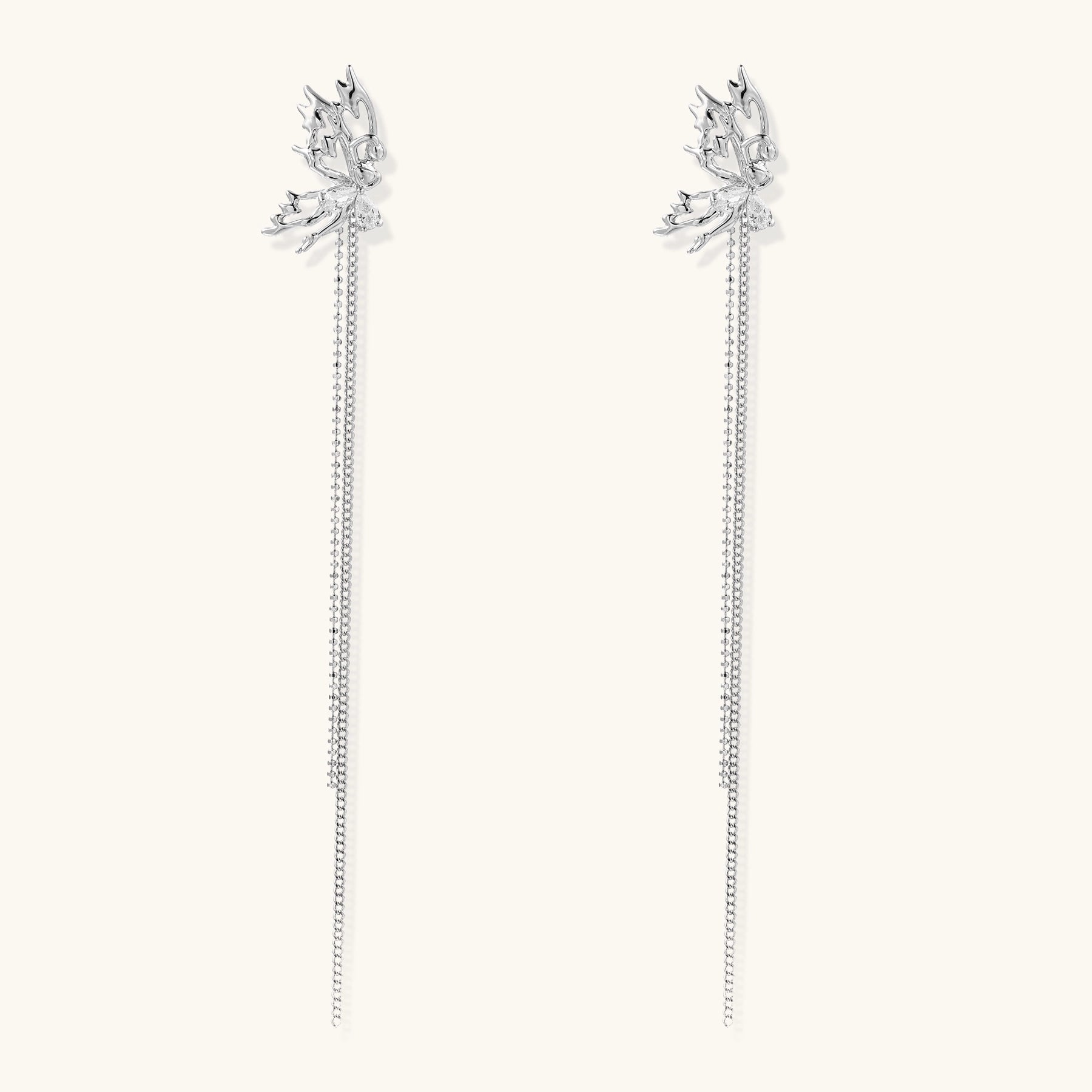 Long gold-plated earrings with star motifs and delicate chain tassels cascading down, featuring zirconia accents.
