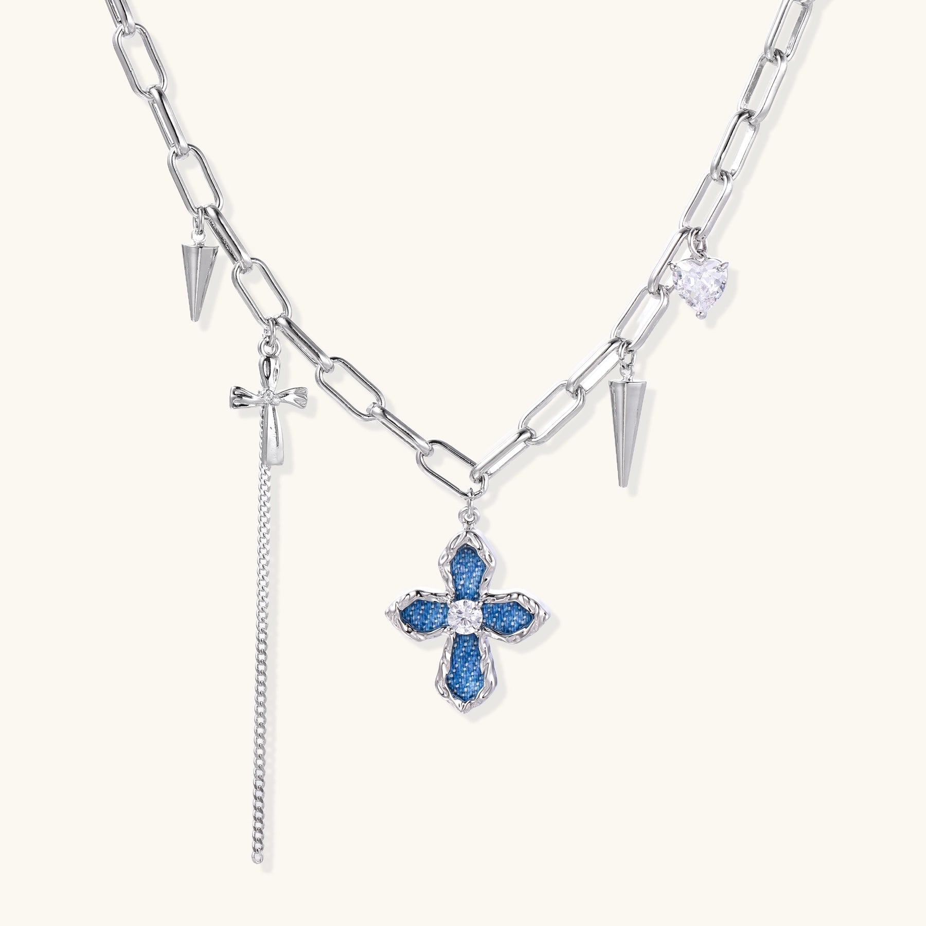 18K gold plated brass chain necklace featuring blue cross pendant with zirconia center stone and spike charms on white background.
