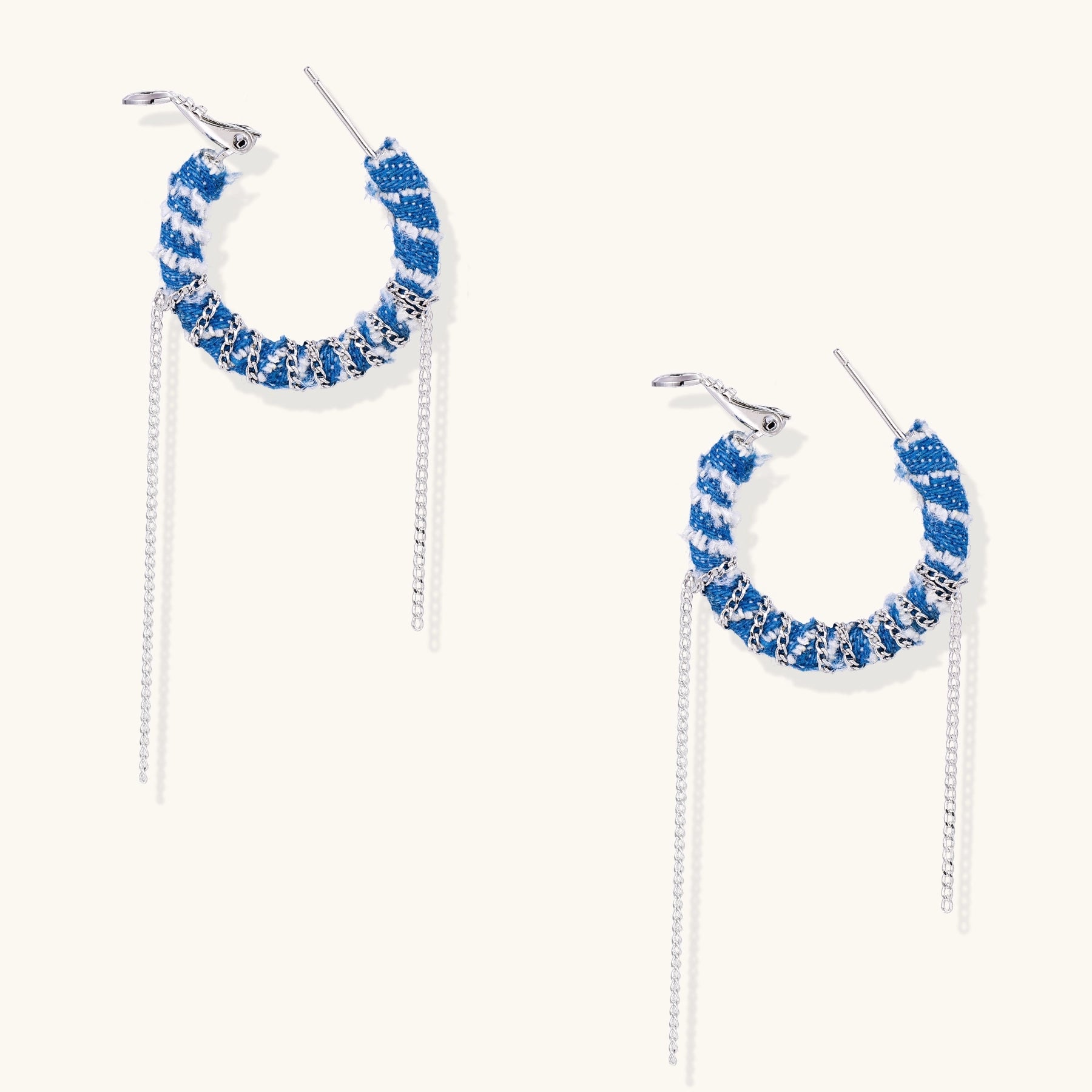 Blue and white checkered denim-wrapped hoop earrings with delicate silver chain dangles on neutral background