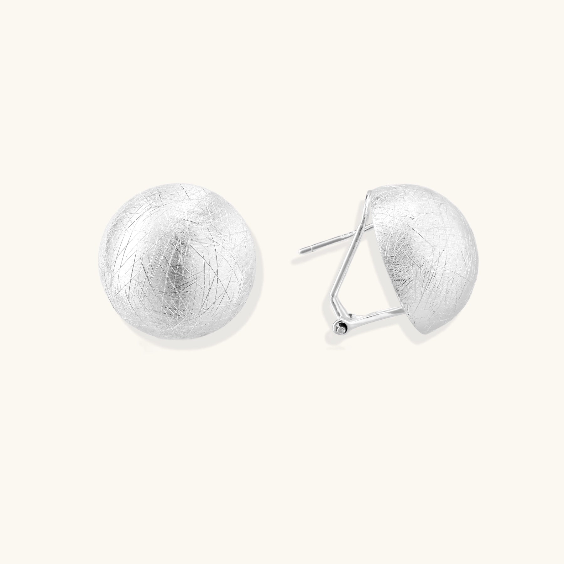 Brushed sterling silver dome-shaped stud earrings with textured surface and secure lever-back closure on white background.