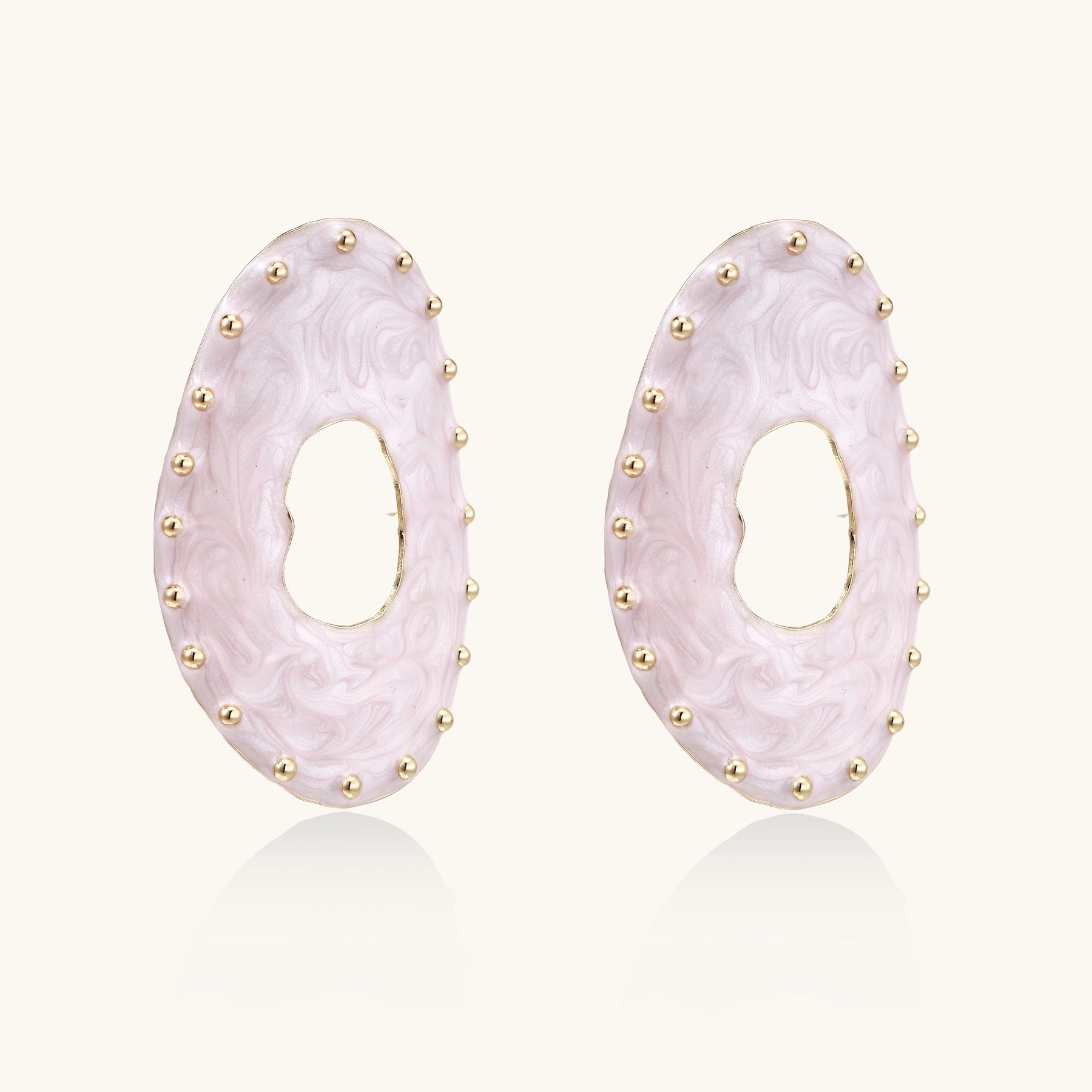 Oval lavender enamel earrings with gold studs around perimeter and cutout centers on white background