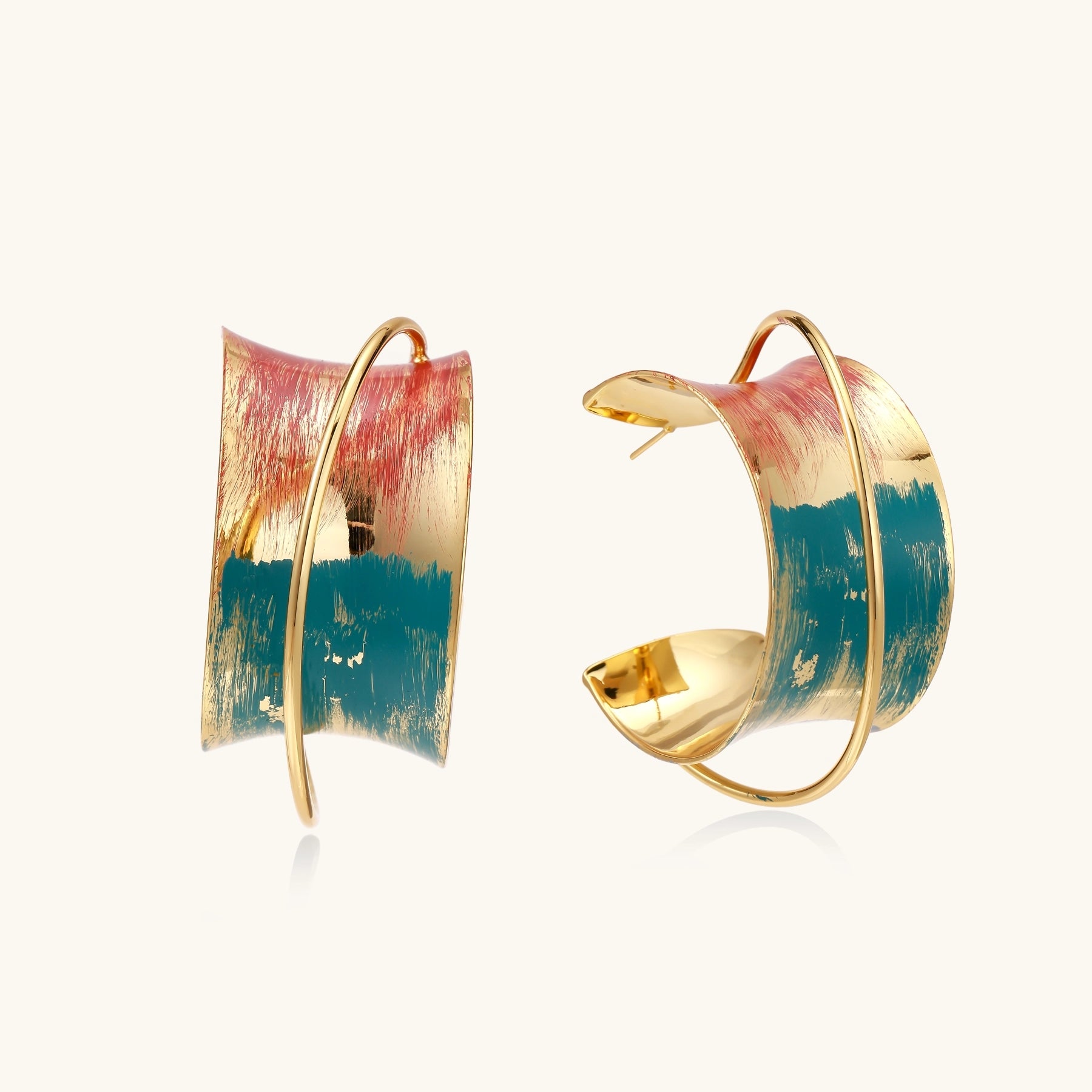 Gold-plated hoop earrings with colorful enamel brushstroke patterns in turquoise, coral, and gold tones