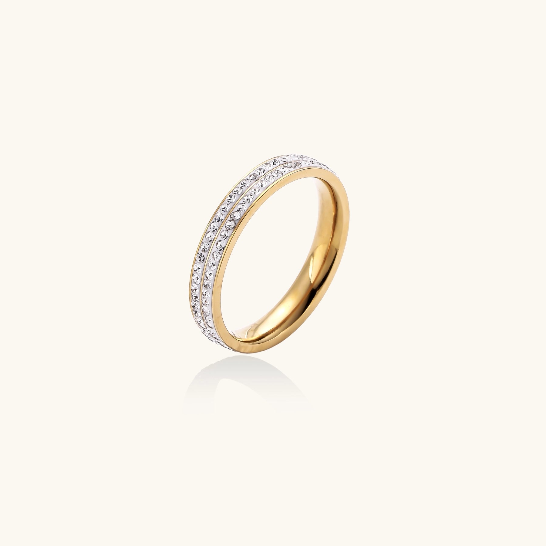 Gold-plated stainless steel ring with two parallel rows of rhinestones creating sparkling geometric bands.