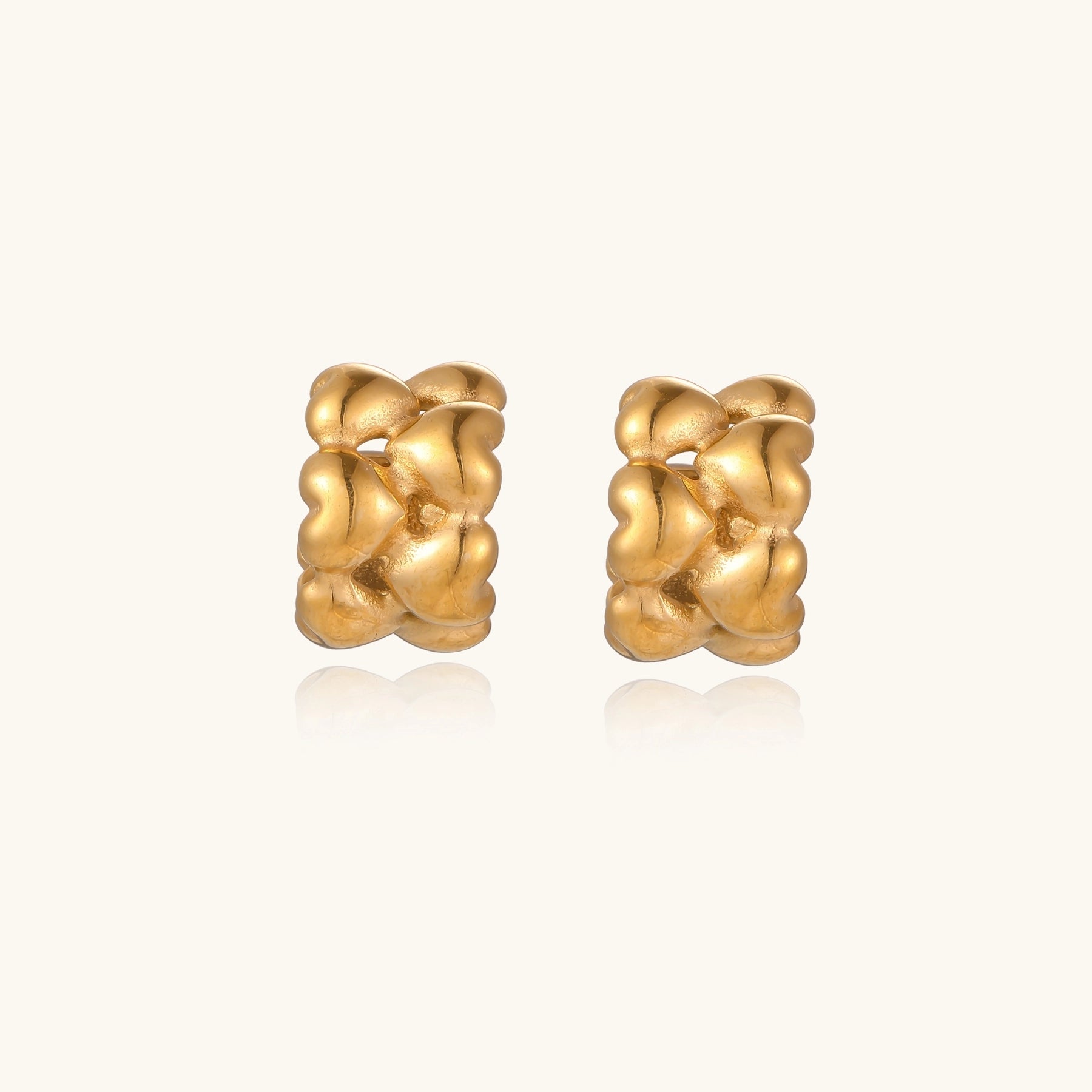 Small gold-plated hoop earrings with intricate braided texture pattern and post backs on white background.